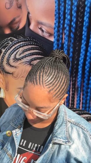 Detailed cornrow pattern gathered into a braided updo