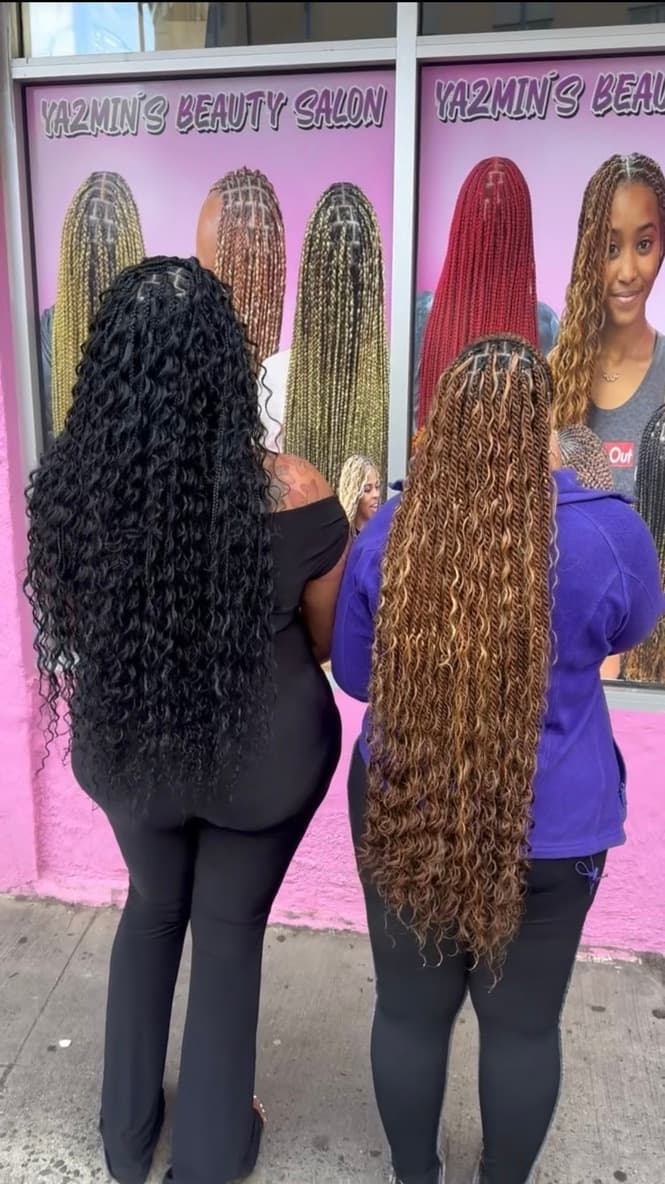Woman with knotless braids in a warm beauty salon